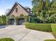 Beautiful home featuring a brick facade, two-car garage and mature landscaping around the home at 2432 Westfield Rd, Charlotte, NC 28207