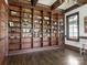 Library showcasing a floor-to-ceiling custom wood bookcase with a collection of decor and books at 2432 Westfield Rd, Charlotte, NC 28207