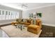 Cozy living room with a large sectional sofa, plush rug, and plenty of natural light from the windows at 2432 Westfield Rd, Charlotte, NC 28207