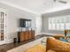Comfortable living room with a media center, large windows, and a plush rug and a sectional sofa at 2432 Westfield Rd, Charlotte, NC 28207
