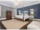 Calming main bedroom suite with four poster bed, designer decor, and ample natural light at 2432 Westfield Rd, Charlotte, NC 28207