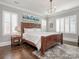 Inviting bedroom with a dark wood bed frame, and modern decor at 2432 Westfield Rd, Charlotte, NC 28207