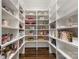 Well-organized walk-in pantry with white shelving, maximizing storage and accessibility at 2432 Westfield Rd, Charlotte, NC 28207