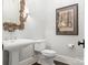 Elegant powder room with decorative mirror, pedestal sink, and classic fixtures at 2432 Westfield Rd, Charlotte, NC 28207