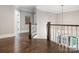 Open upstairs landing with hardwood floors, chandelier, and view of staircase at 2432 Westfield Rd, Charlotte, NC 28207