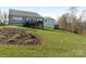 Expansive backyard with landscaping leading up to a two-story home featuring a deck and stair access at 2894 Westshore Pl, Denver, NC 28037