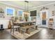 Bright dining room with a large wooden table, bench, and elegant light fixture at 2894 Westshore Pl, Denver, NC 28037