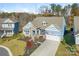 Charming two-story home featuring a stone facade, blue accents, an attached garage and manicured front yard at 2894 Westshore Pl, Denver, NC 28037