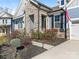 Close-up of home's facade, stone accents, and landscaping that includes a variety of shrubs and flowers at 2894 Westshore Pl, Denver, NC 28037