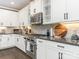 Modern kitchen with white cabinets, stainless steel appliances, and granite countertops at 2894 Westshore Pl, Denver, NC 28037