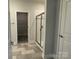 Bright bathroom features a glass enclosed shower and tile flooring, with a view into the walk-in closet at 2924 Noritake Trl # 59, Albemarle, NC 28001