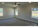Spacious carpeted bedroom with three large windows providing ample natural light at 2924 Noritake Trl # 59, Albemarle, NC 28001