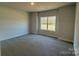 A simple bedroom with neutral colored walls, carpeting and natural lighting from the window at 2924 Noritake Trl # 59, Albemarle, NC 28001
