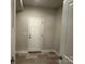 Hallway area with tile flooring, a white door, and light gray colored walls at 2924 Noritake Trl # 59, Albemarle, NC 28001