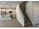 Kitchen and stairwell with white cabinets, a stainless steel refrigerator, and carpeted stairs at 2924 Noritake Trl # 59, Albemarle, NC 28001