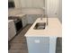 Bright kitchen island with quartz countertops, stainless steel sink, and modern appliances at 2924 Noritake Trl # 59, Albemarle, NC 28001