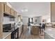 Modern kitchen boasts stainless steel appliances, a central island, and a seamless flow into the dining and living areas at 2950 Old Cliffside Rd, Shelby, NC 28152