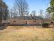 A well-maintained backyard featuring a brick home exterior, patio, and lush landscaping at 3142 Wimbledon Ln, Rock Hill, SC 29732