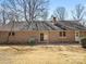 Backyard view of the property, showing brick exterior, brick patio, and landscaping details at 3142 Wimbledon Ln, Rock Hill, SC 29732
