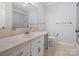 Bright bathroom features a single sink vanity with storage, a large mirror, and tiled floors at 3142 Wimbledon Ln, Rock Hill, SC 29732