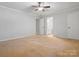 A bright bedroom features neutral walls, carpet, and a ceiling fan for added comfort at 3142 Wimbledon Ln, Rock Hill, SC 29732