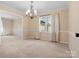 Dining room featuring neutral carpeting and a decorative chandelier at 3142 Wimbledon Ln, Rock Hill, SC 29732