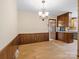 Cozy dining room with wood paneling, a classic chandelier, and access to the kitchen at 3142 Wimbledon Ln, Rock Hill, SC 29732