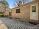 A home's backyard features a brick exterior and a stone tile patio at 3142 Wimbledon Ln, Rock Hill, SC 29732