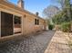 A home's backyard features a brick exterior and a stone tile patio at 3142 Wimbledon Ln, Rock Hill, SC 29732
