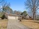 Charming brick home featuring a large two-car garage, beautiful landscaping, and a well-manicured lawn at 3142 Wimbledon Ln, Rock Hill, SC 29732