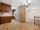 Open-concept kitchen featuring wood cabinets, a brick partition, and seamless flow to other living spaces at 3142 Wimbledon Ln, Rock Hill, SC 29732