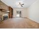 Bright living room featuring a brick fireplace, built-in shelves, and sliding glass doors to the backyard at 3142 Wimbledon Ln, Rock Hill, SC 29732