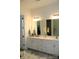 Bathroom featuring double sinks, a large mirror and white cabinetry at 3309 Juneberry Pl, Indian Land, SC 29707