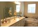 Bathroom featuring double sinks, soaking tub, and large mirror at 3309 Juneberry Pl, Indian Land, SC 29707