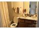 Well-lit bathroom featuring granite countertop vanity, neutral color scheme, and shower with patterned curtain at 3309 Juneberry Pl, Indian Land, SC 29707