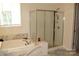 Bright bathroom featuring a soaking tub and glass enclosed shower at 3309 Juneberry Pl, Indian Land, SC 29707