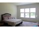 Bright bedroom featuring a large window and neutral carpet at 3309 Juneberry Pl, Indian Land, SC 29707