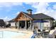 Upscale clubhouse with an inviting pool area, elegant outdoor furniture, and architectural design for community gatherings at 3309 Juneberry Pl, Indian Land, SC 29707