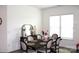 Cozy dining room features an elegant table set for six and large window for ample lighting at 3309 Juneberry Pl, Indian Land, SC 29707