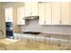 Well-lit kitchen boasts white cabinetry, stainless steel appliances, granite counters, and gas cooktop at 3309 Juneberry Pl, Indian Land, SC 29707