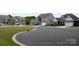 Street view featuring newly constructed homes with well-manicured lawns and modern architectural details on a sunny day at 3309 Juneberry Pl, Indian Land, SC 29707