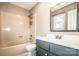 Bathroom featuring a vanity with dark gray cabinets, a large mirror, and a tub-shower combo at 342 Monticello Rd, Statesville, NC 28625