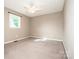 Bright bedroom with neutral walls, carpet flooring, and a ceiling fan, creating a serene and inviting space at 342 Monticello Rd, Statesville, NC 28625