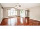 Bright living room with hardwood floors, large windows, and a vaulted ceiling at 342 Monticello Rd, Statesville, NC 28625