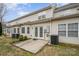 A townhouse featuring a back patio area with white French doors and neutral siding at 349 Valley Brook Se Ln, Concord, NC 28025