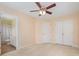 Neutral bedroom with fan, carpeted floor, and ensuite bathroom and closet at 349 Valley Brook Se Ln, Concord, NC 28025