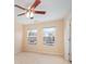 Neutral bedroom with fan, carpeted floor, and two bright windows at 349 Valley Brook Se Ln, Concord, NC 28025