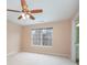 Neutral bedroom with fan, carpeted floor, large window, and ensuite bathroom at 349 Valley Brook Se Ln, Concord, NC 28025