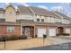 Charming townhome featuring brick facade, attached garage, and landscaped front yard at 349 Valley Brook Se Ln, Concord, NC 28025