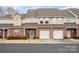 Charming townhome featuring brick facade, attached garage, and landscaped front yard at 349 Valley Brook Se Ln, Concord, NC 28025